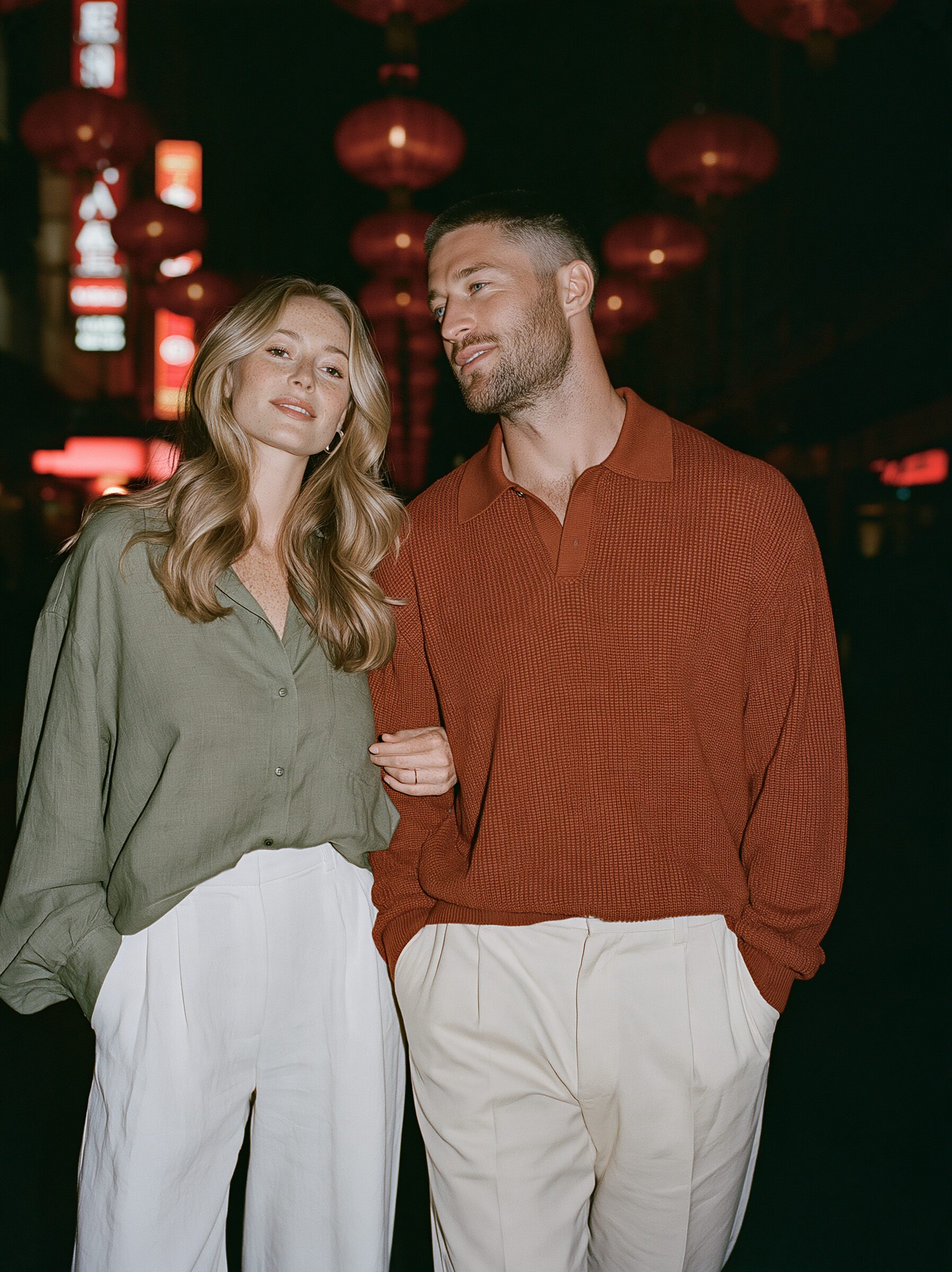 Couple walking arm in arm beneath glowing red lanterns on Little Bourke Street in Chinatown at night