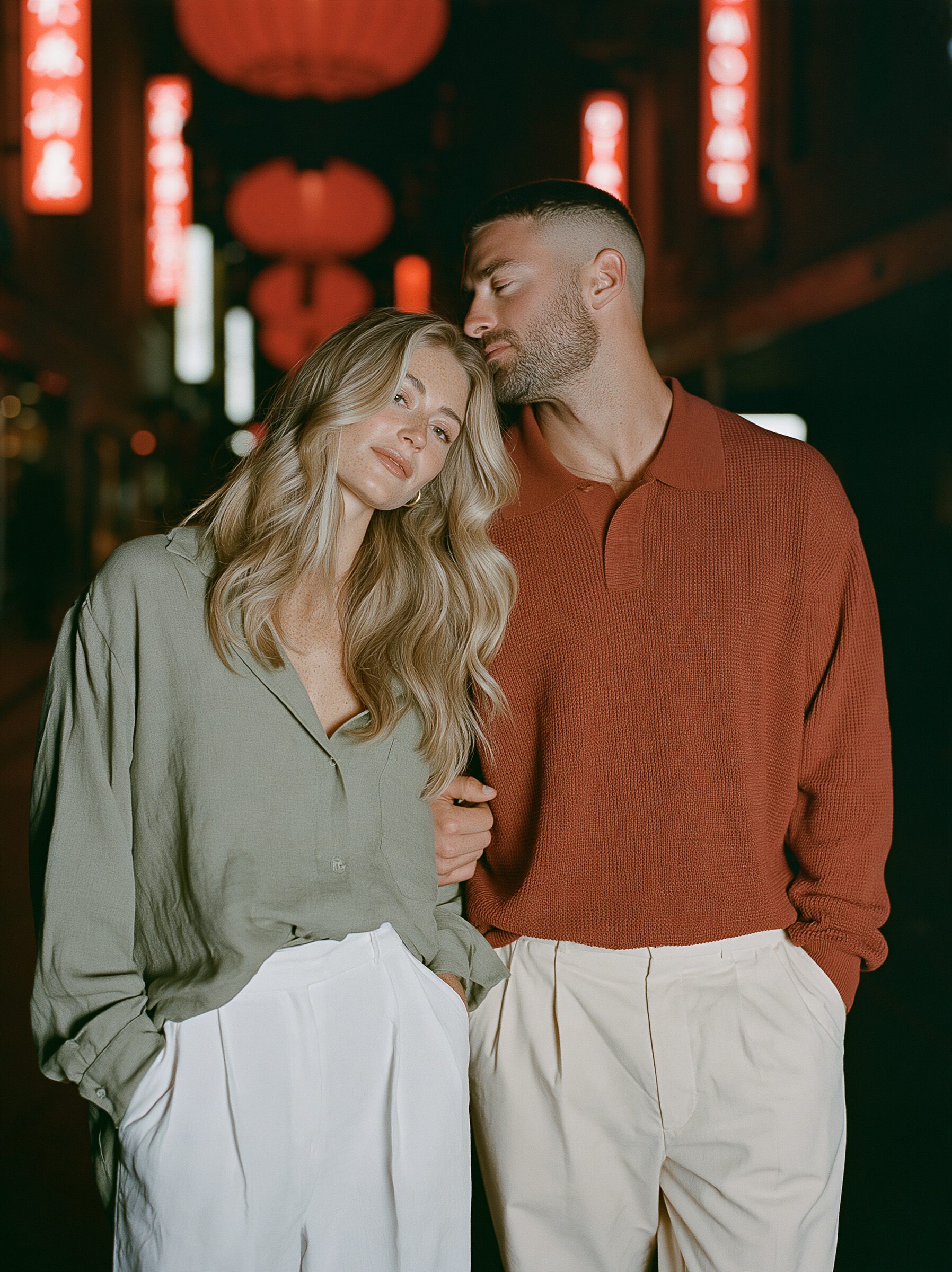 Couple walking arm in arm beneath glowing red lanterns on Little Bourke Street in Chinatown at night