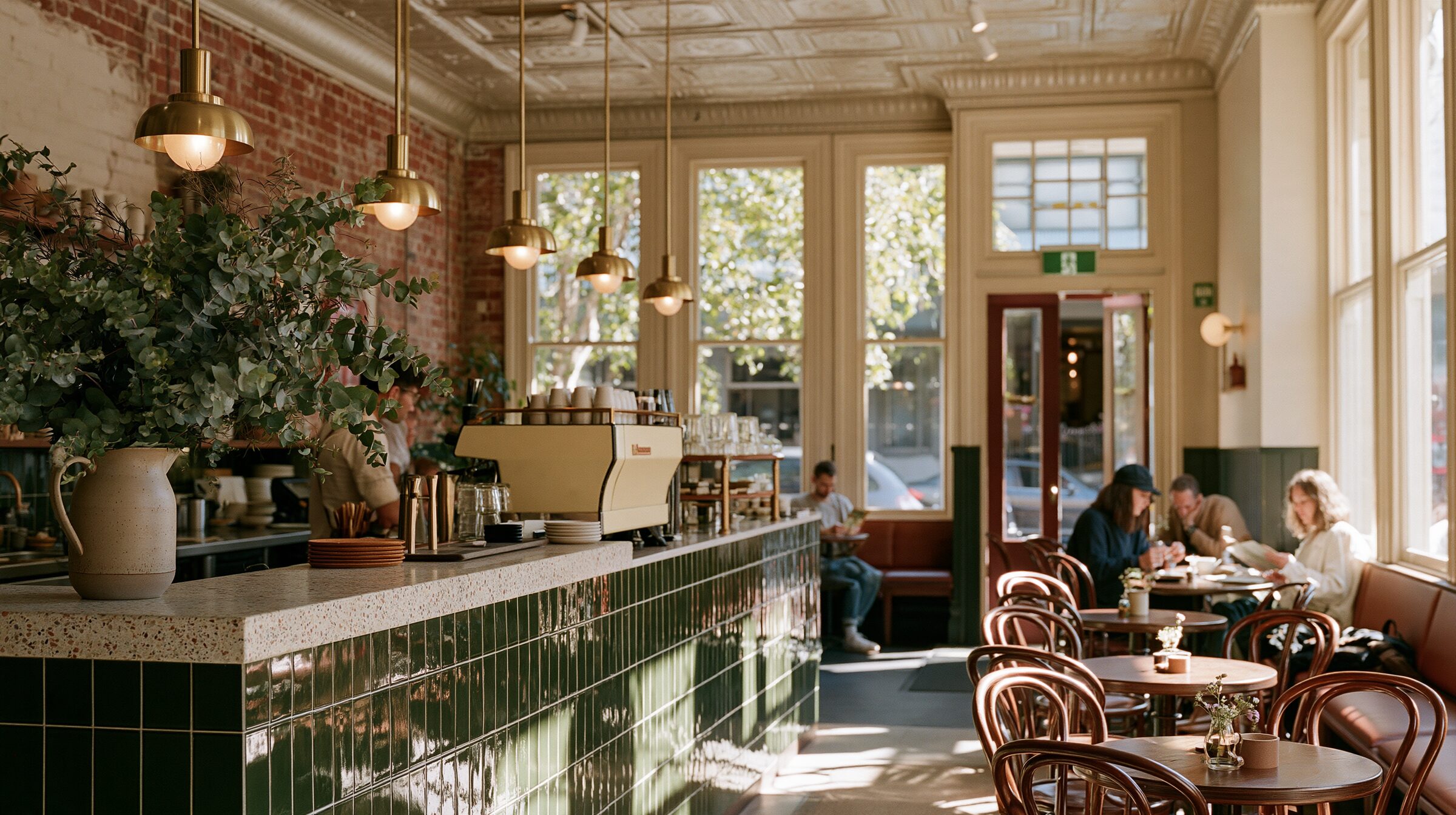 Interior of Lacework: pressed-metal ceiling, red brick, green-tiled counter and bentwood chairs